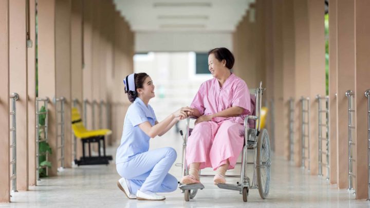 Elder Woman in Wheelchair with Caregiver
