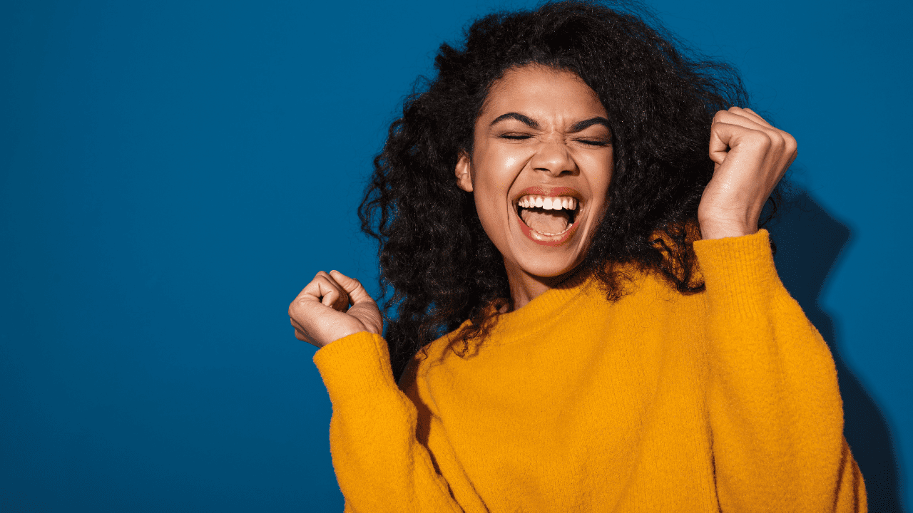 woman is excited about freebies she can get with orange county public libraries card