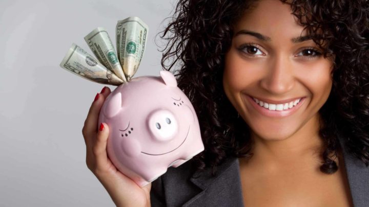 woman holds piggy bank