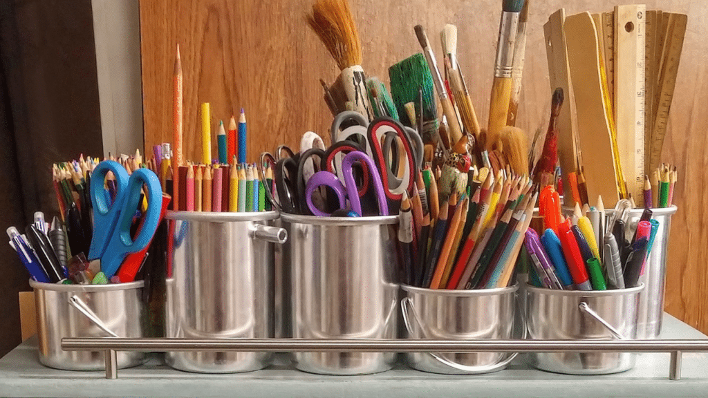 a tray of pencils, paintbrushes and other free school supplies in Greensboro NC