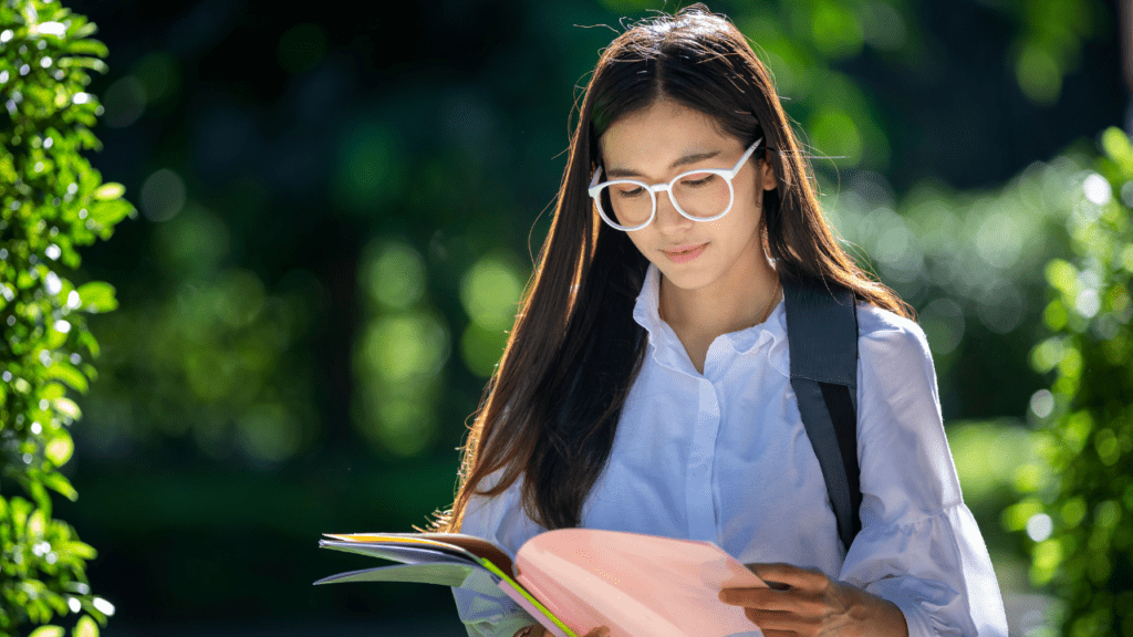 girl walks while reading free book she received with free school supplies in south gate ca