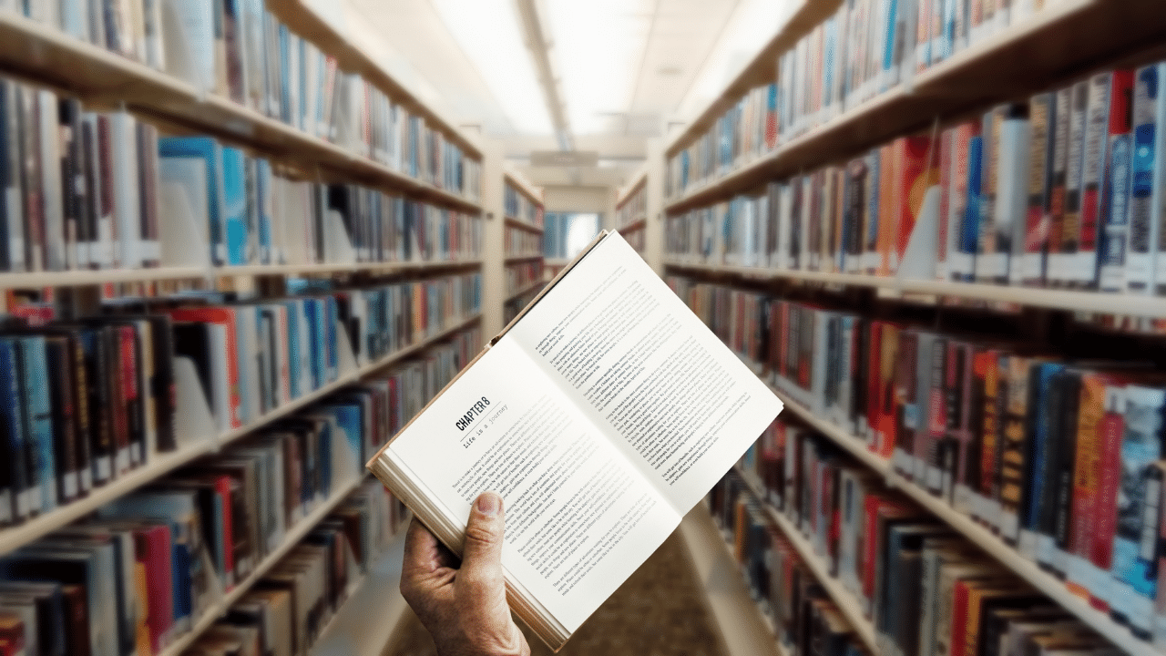 person holds up book at the new bern library in south carolina