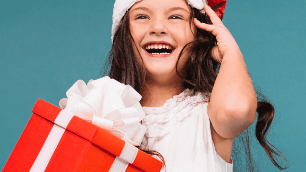 girl receives gift from free Christmas help program in Wisconsin