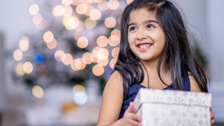 child receives free gifts from Christmas help program in Phoenix Arizona