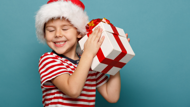 happy boy receives presents after parents apply for free Christmas gifts in Florida