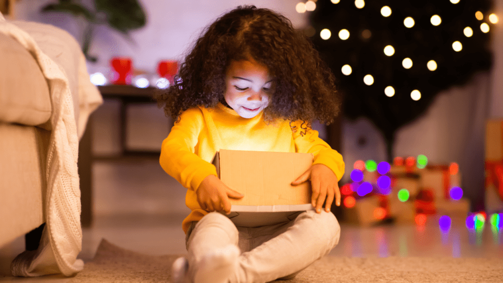 girl enjoys free Christmas gifts from charities in Oregon