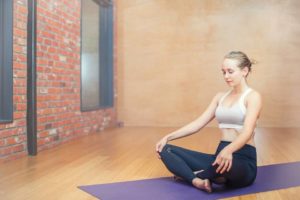 woman doing yoga with free gym pass