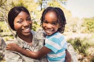 Military family (mother and son) smile and enjoy Memorial Day specials