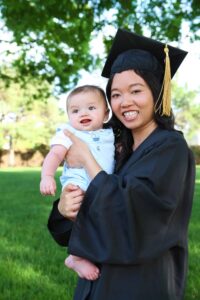 graduate holds her baby thanks to scholarships for single moms