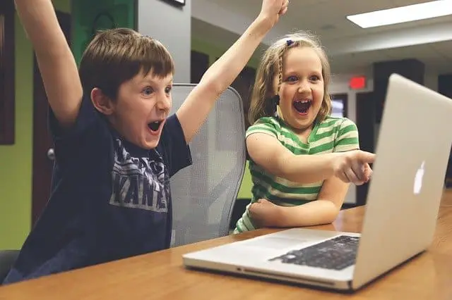 children celebrate finding free computers for low income families