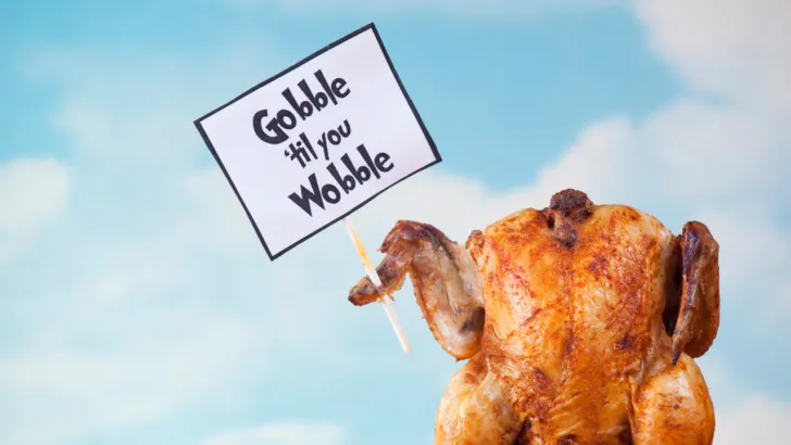 free Thanksgiving dinner turkey holds sign that says gobble til you wobble