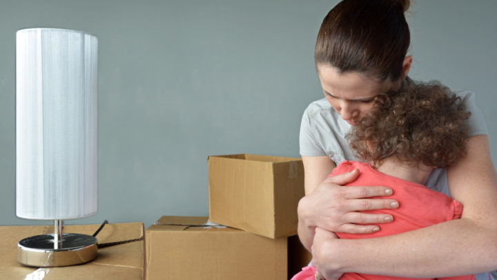 Sad evicted mother with child after eviction ban ends