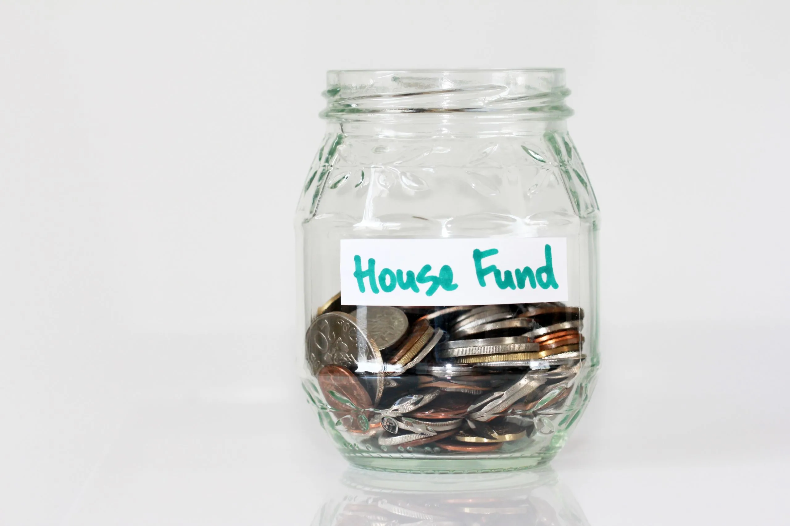 coin jar labeled with the words "house fund" in article about how to get free money