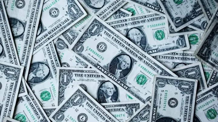 A pile of layered U.S. dollar bills in article on how to use ebt cash benefits
