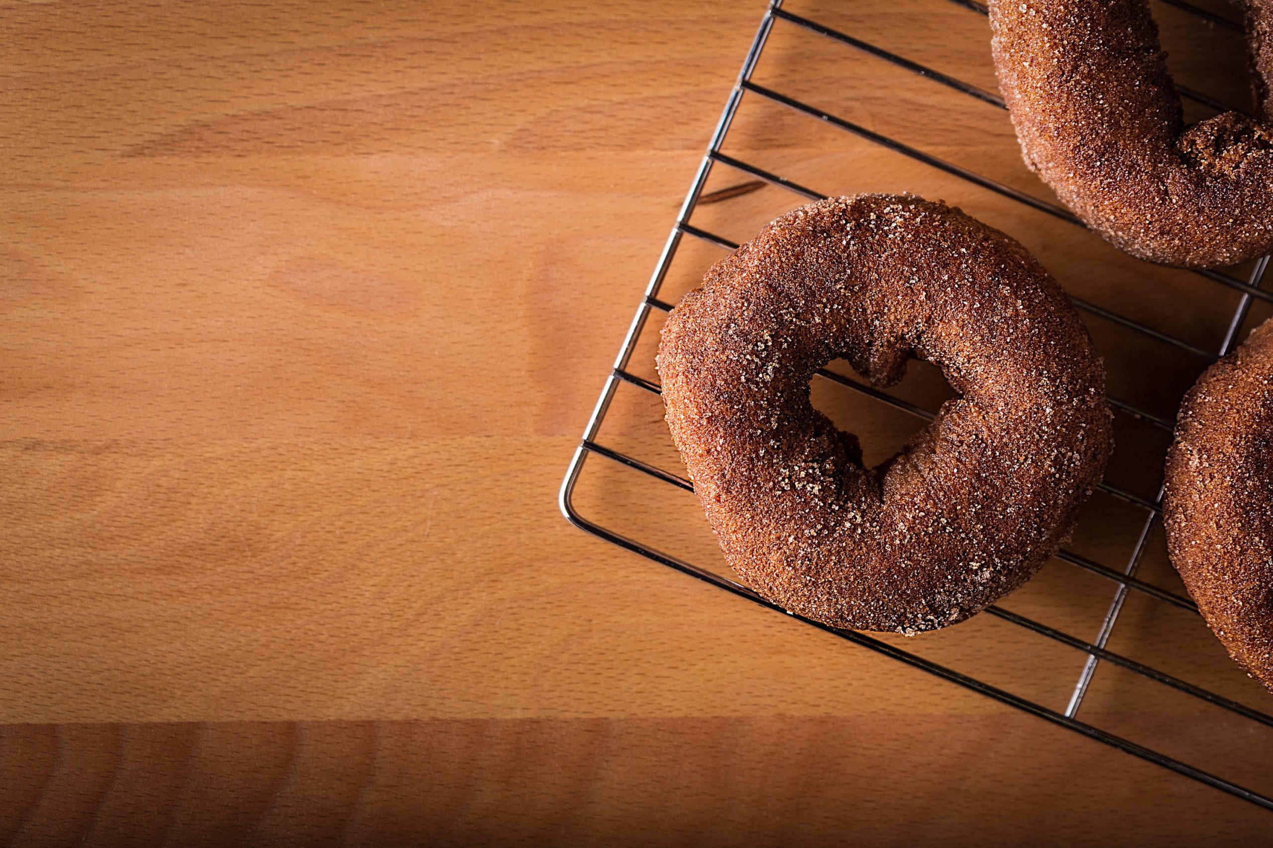 Doughnuts cooling on a cooling rack in article about free stuff for single moms