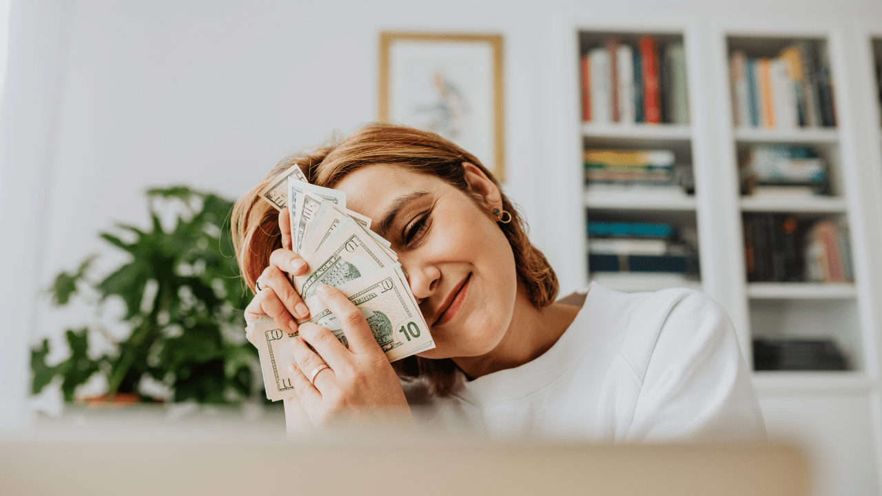 woman holds cash after donating blood plasma in article about what to donate for money