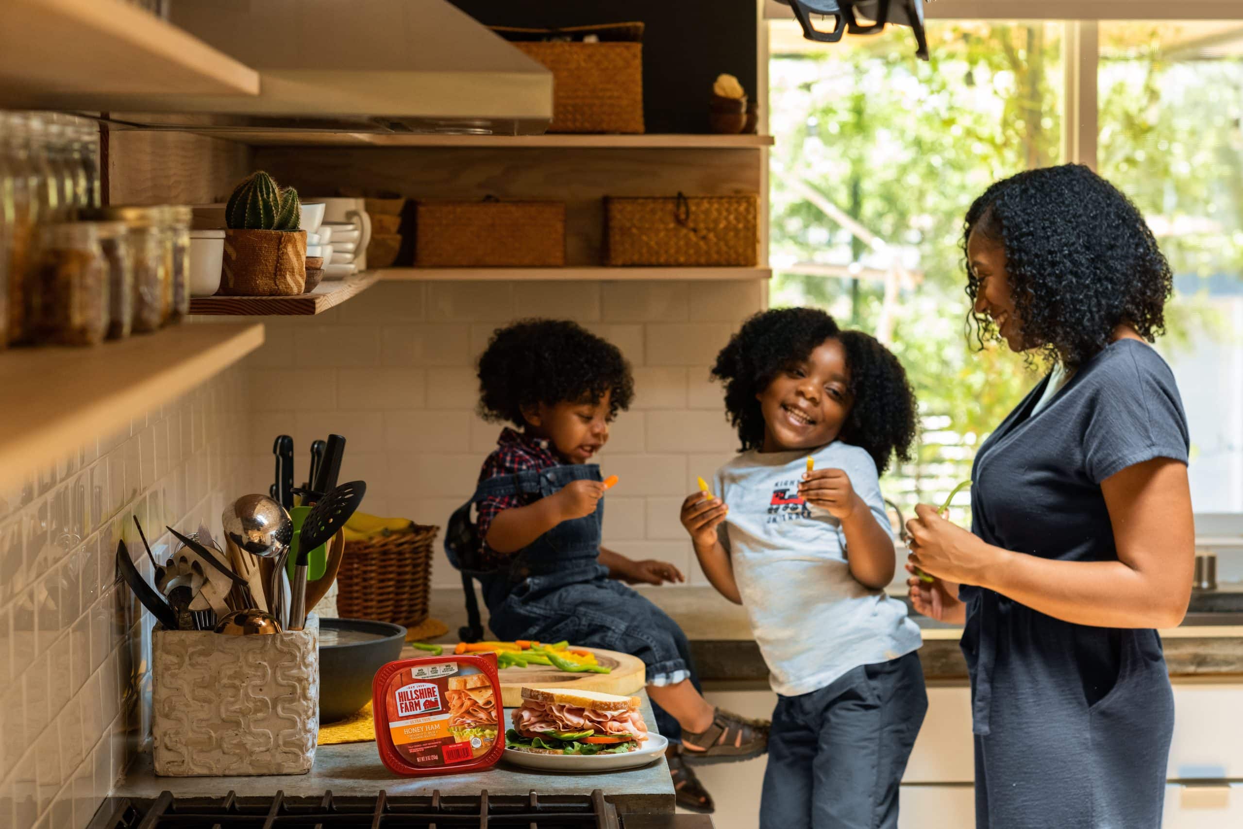 mother and two children in their kitchen in article on Colorado Works