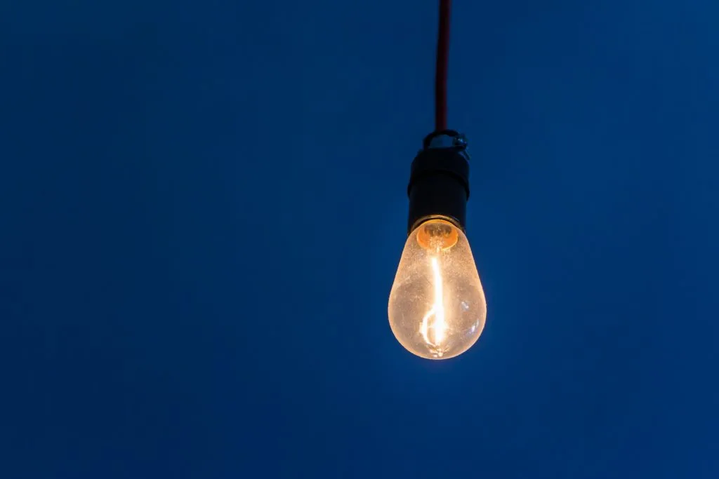 image of lightbulb hanging against a dark sky in article on financial assistance in the us virgin islands