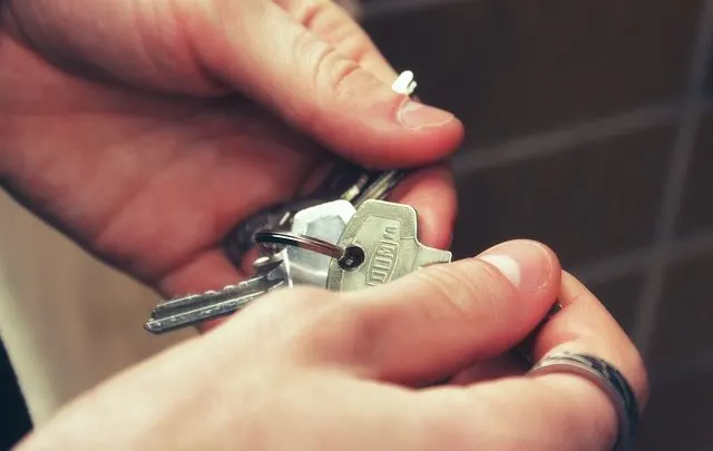 person fumbles with keys after receiving nebraska rent assistance