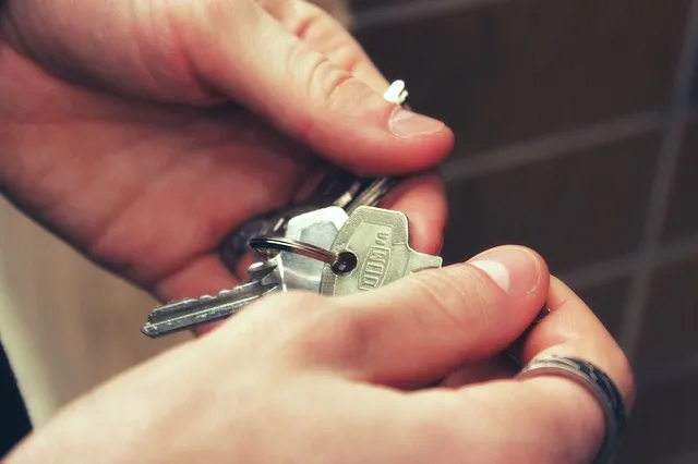person fumbles with keys after receiving nebraska rent assistance