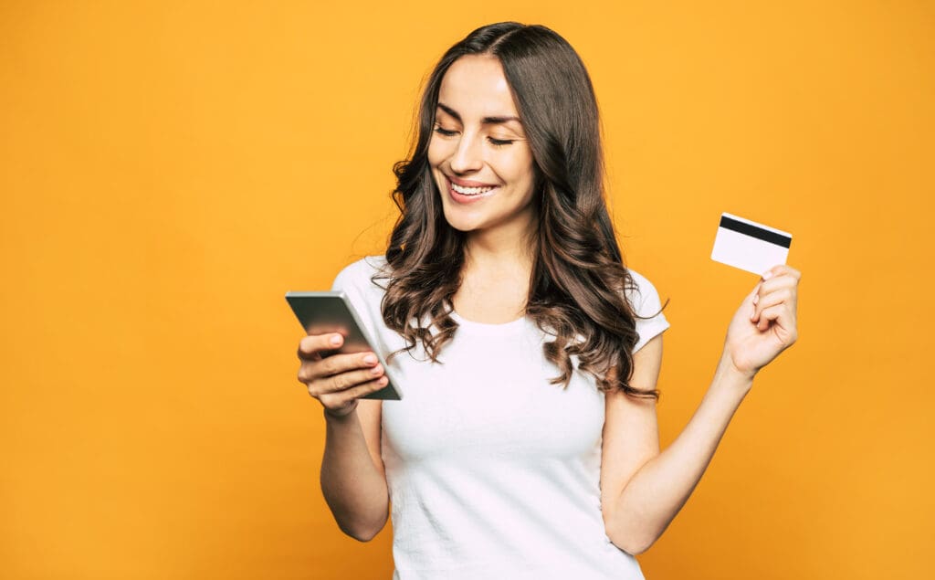 woman uses sesame cash, the debit card that builds credit