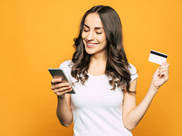 woman uses sesame cash, the debit card that builds credit