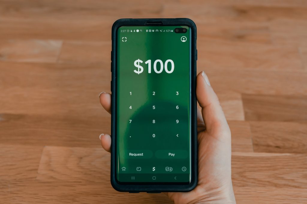 By Unsplash user Tech Daily. An iPhone with a Venmo app open ready to transfer one hundred dollars is shown. Before you send that money - check for Venmo scams!