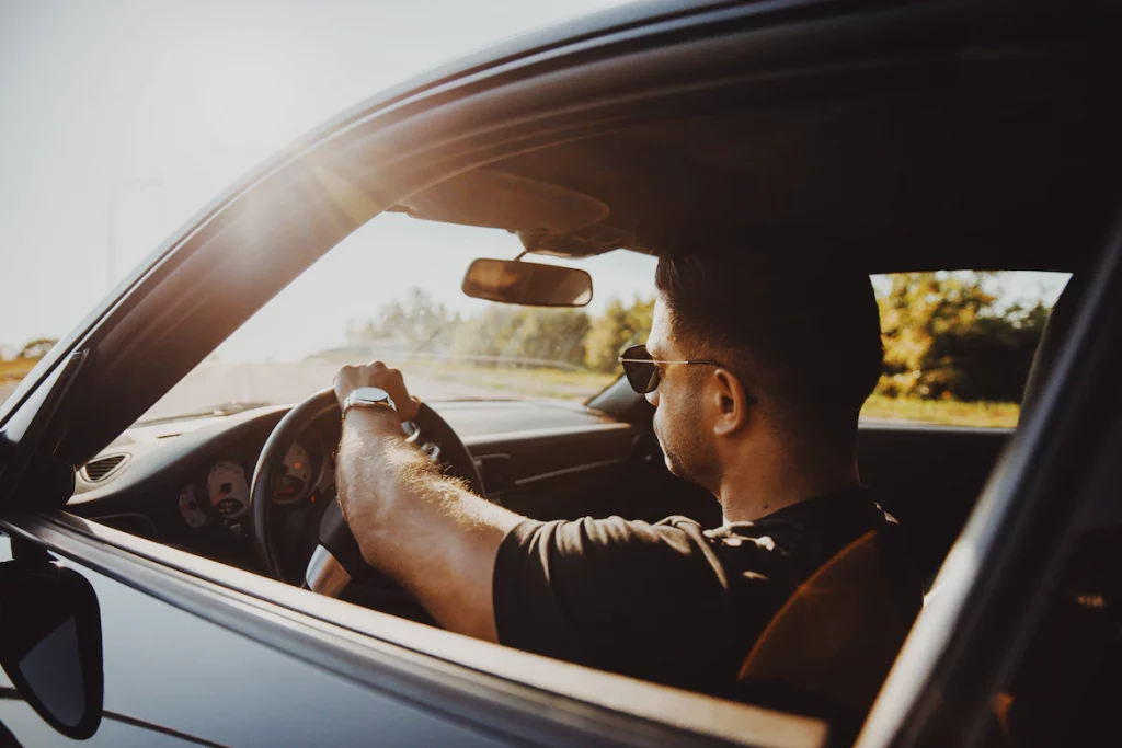 By Unsplash user Serjan Midili. This man is now back on the road driving his car after getting his driver's license back.
