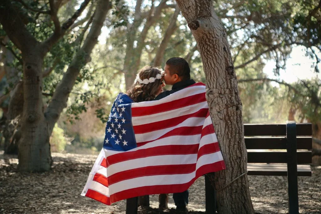 couple enjoying citizenship and the american flag