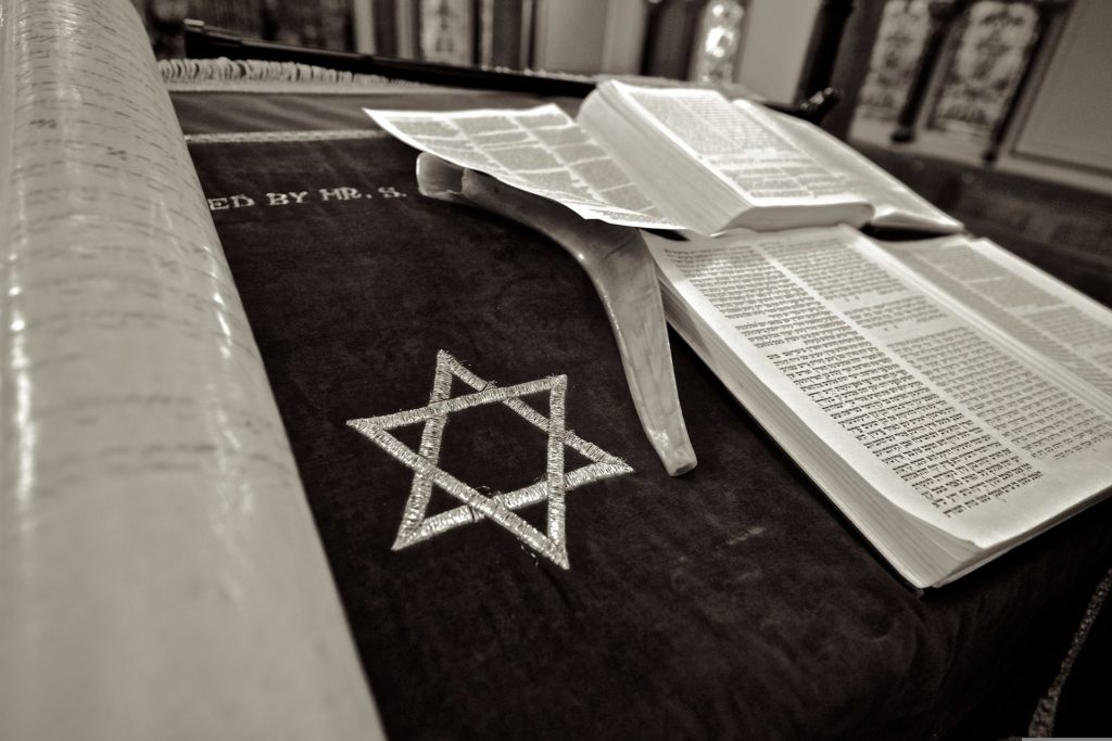 Star of David and Jewish scripture open on a podium.