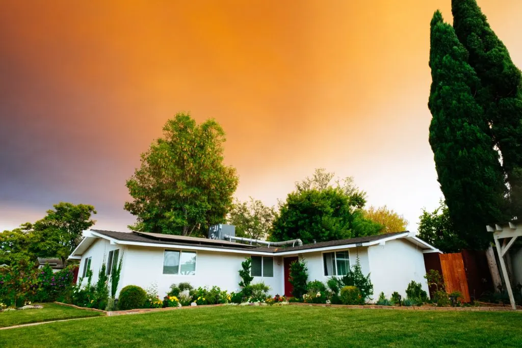 house in front of sunset in article on how do i get assistance with rent?
