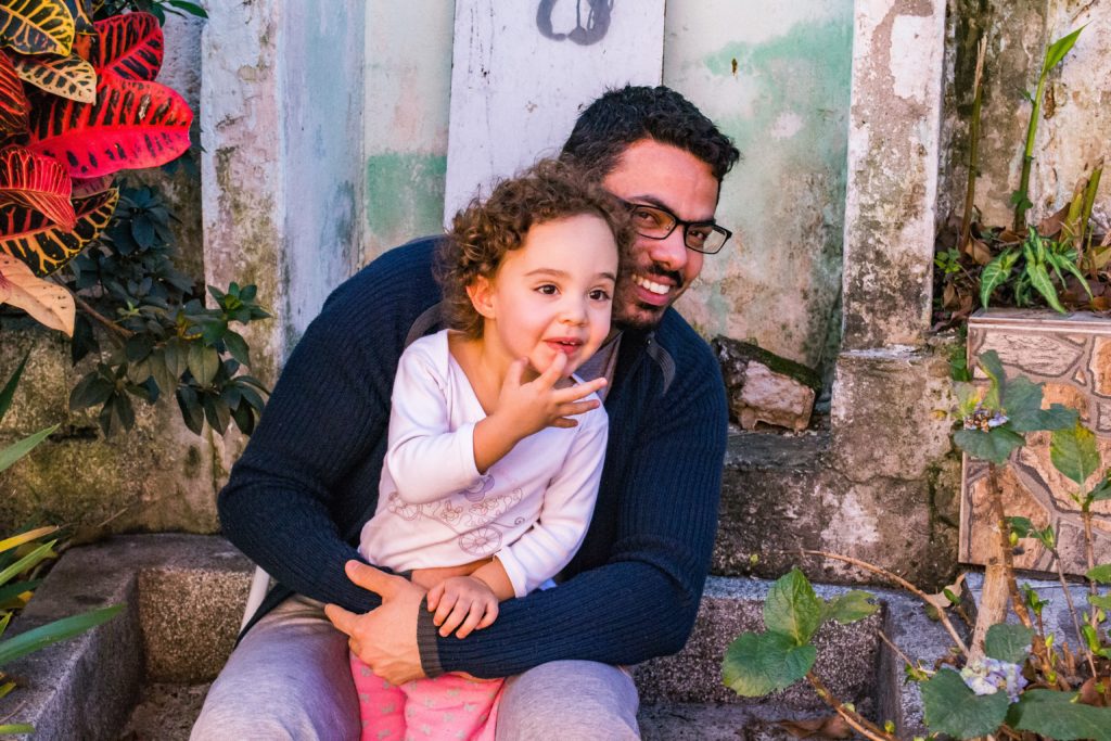 man holding his daughter in article on single dad needs money