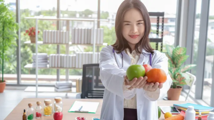 doctor holds up fresh fruit prescribed through freshrx