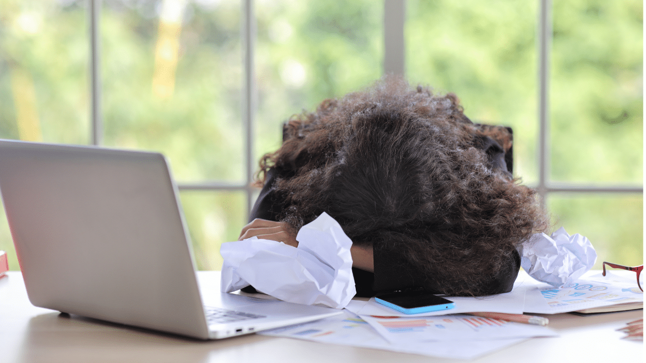 woman places head on desk in discouragement after reading the the affordable connectivity program has ended