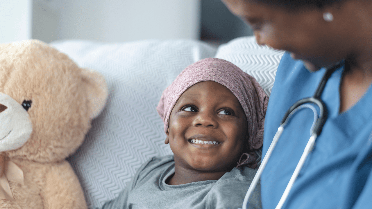 child smiles thanks to leukemia and lymphoma society financial assistance programs