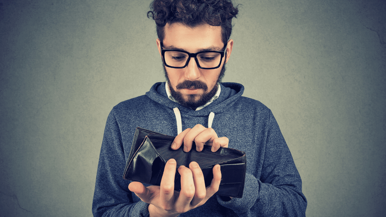 man wonders how to start a nonprofit organization with no money as he looks at empty wallet