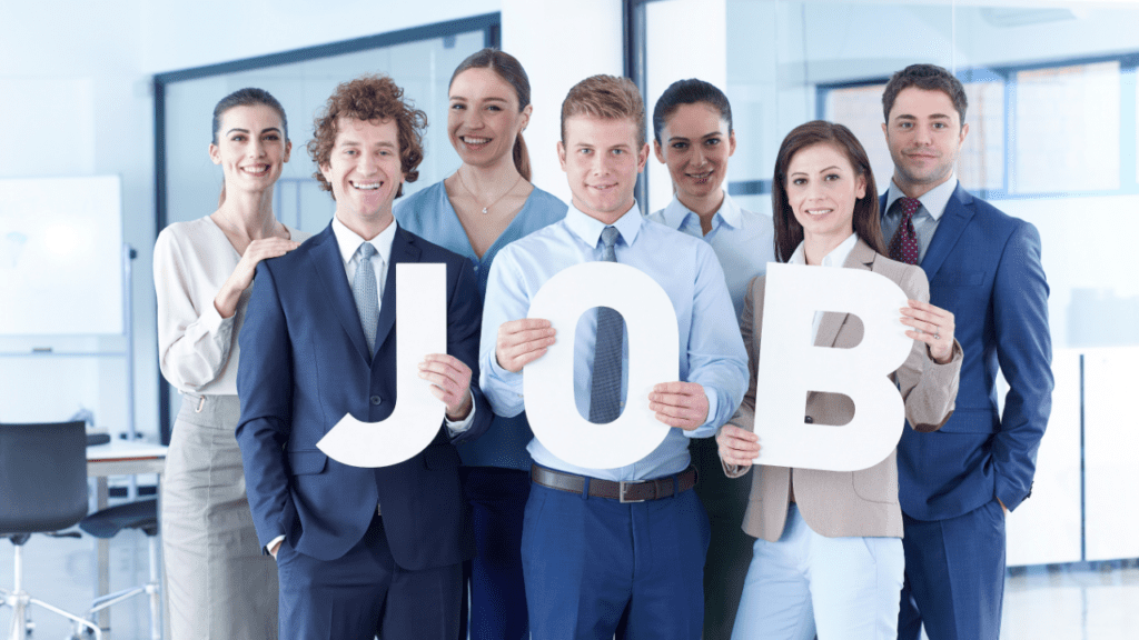 group holds up sign after getting finance jobs with no degree