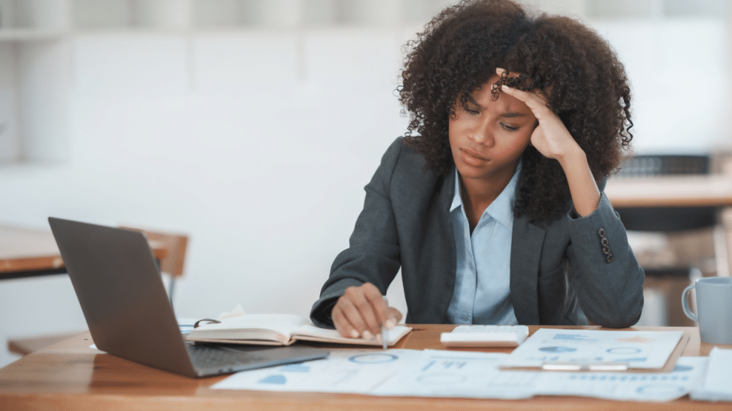woman reviews papers and computer while she looks for overlooked federal benefits that she may have missed