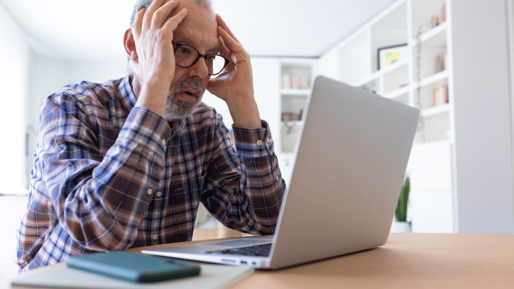 man looks at computer worried after realizing his social security check suddenly stopped